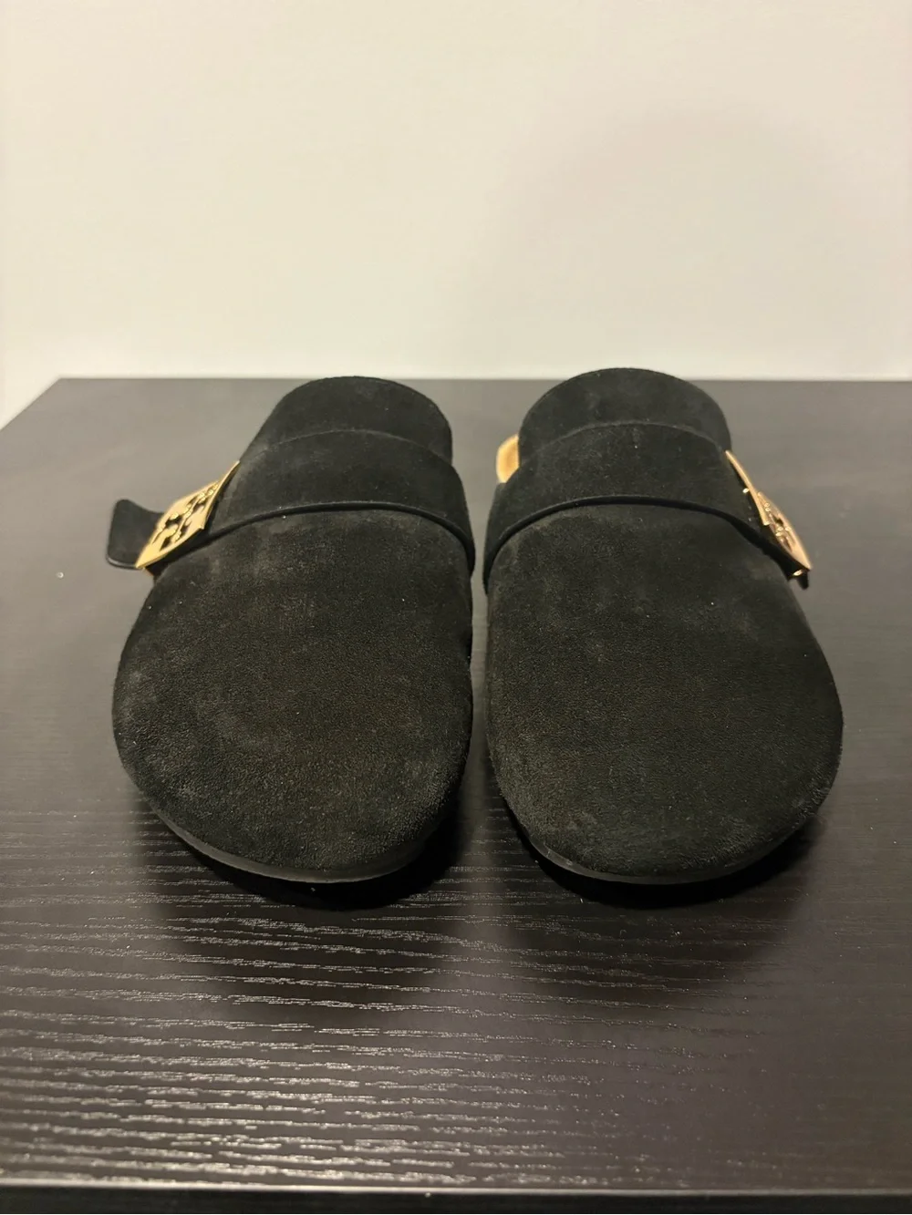 Tory Burch black suede slip-on mules in a size 7.5